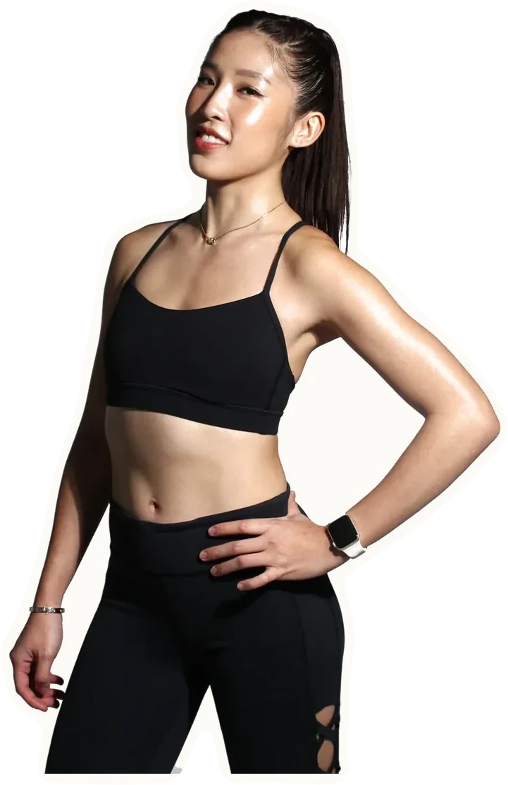 Crystal Lai in a three-quarter studio portrait, one hand on her hip.